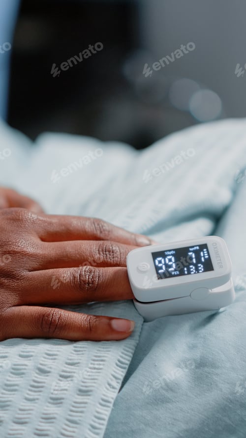 Preview: Close up of oximeter on finger of patient with illness