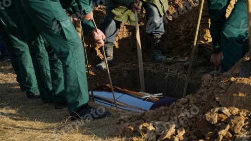 Preview: Religion, death and dolor - coffin bearer carrying casket at funeral to cemetery