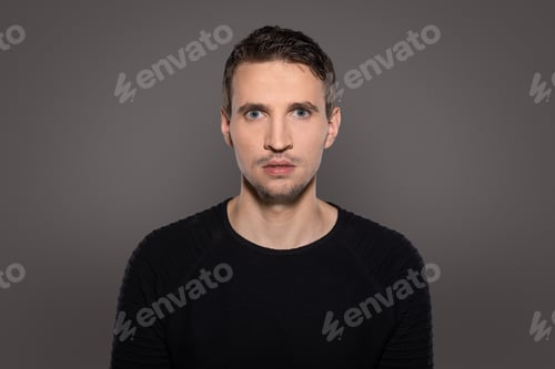 Preview: Closeup of young man with horrified expression stand isolated on grey background and show his mood