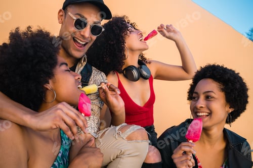 Preview: Multi-ethnic group of friends enjoying summertime while eating ice cream.