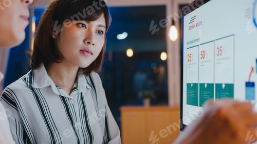 Preview: Asia businessman and businesswoman using computer communication meeting in night home office.