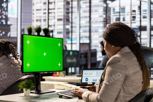 Preview: Female executive seated at her workstation with isolated copy space multitasking