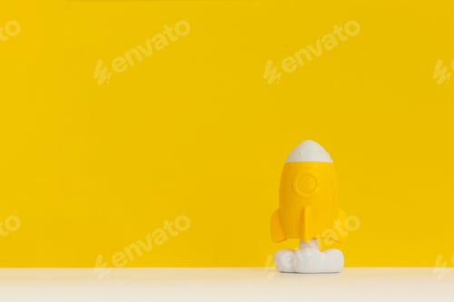 Preview: Rocket on yellow background, startup business idea