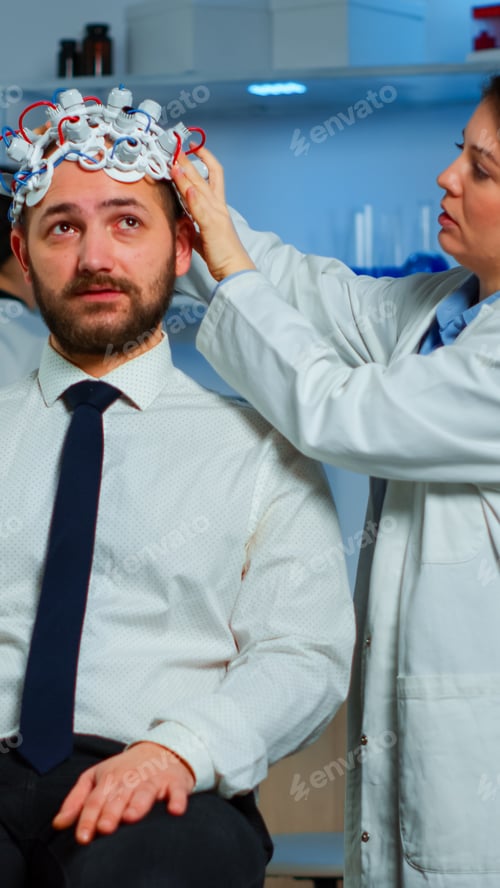Preview: Woman researcher putting brainwave scanning headset
