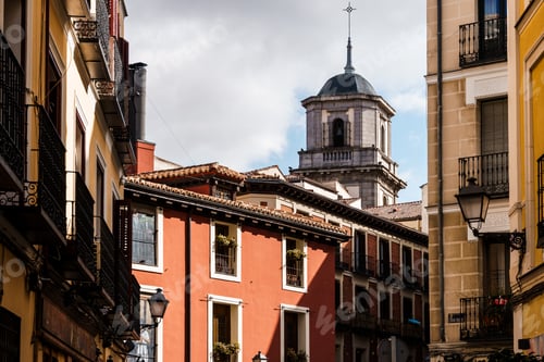 Preview: Charming architecture in Madrid, with a view of historic buildings and a church tower.
