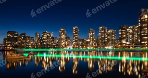 Preview: False Creek with modern city buildings at night after sunset.