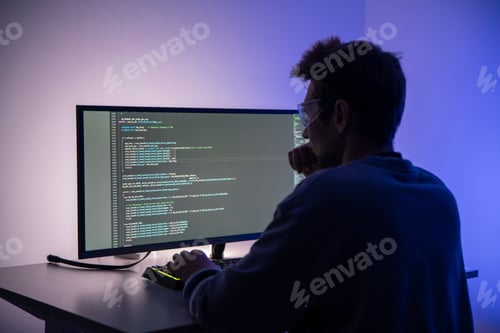 Preview: Silhouetted Figure Engaged in Computer Hacking Activities at Night