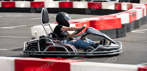 Preview: Girl In Protective Helmet Driving Go-Kart By Racing Track