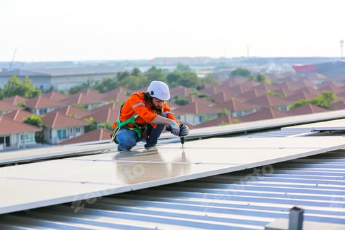 Preview: Workers Installing Solar Panels on warehouse Roof.