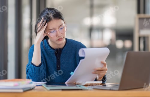 Preview: Portrait of tired young business Asian woman work with documents tax laptop computer in office. Sad,