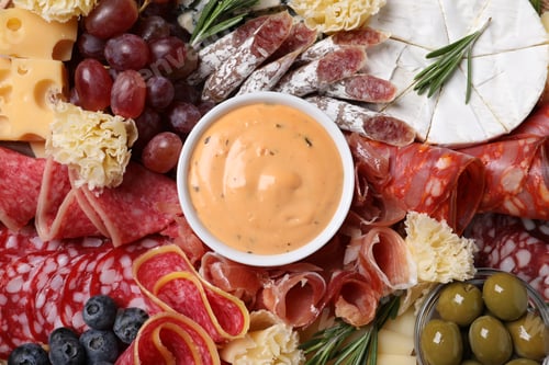 Preview: Different delicious snacks and sauce, top view
