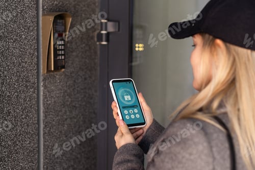 Preview: woman uses smartphone to open the door of his house