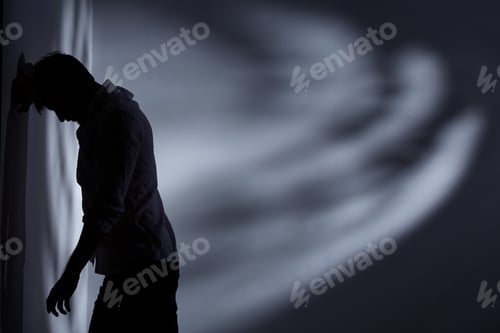 Preview: Man standing close the wall