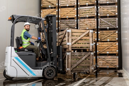 Preview: Employee on electric forklift carry container with ripe apples at storage