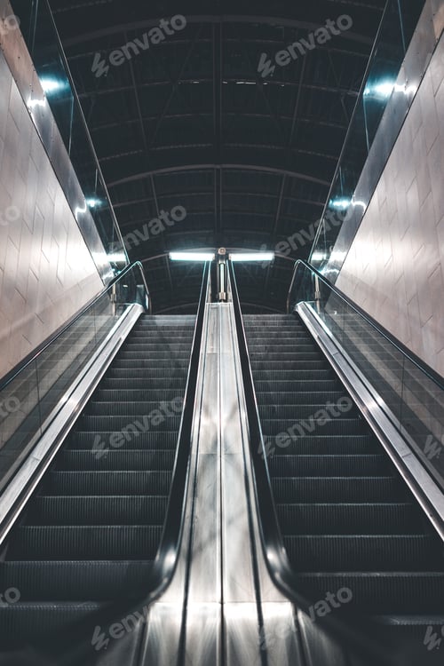 Symmetric Escalator Leads to Interior Subway Platform