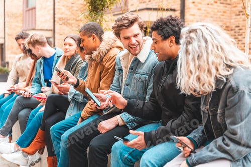 Preview: Multicultural group of friends using smartphone and having fun