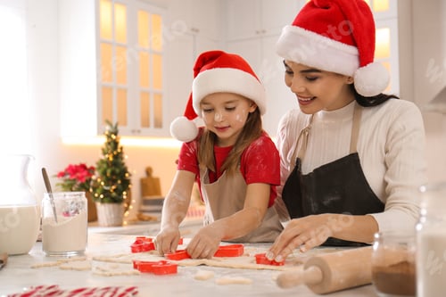 Preview: Mother with her cute little daughter making Christmas cookies in kitchen