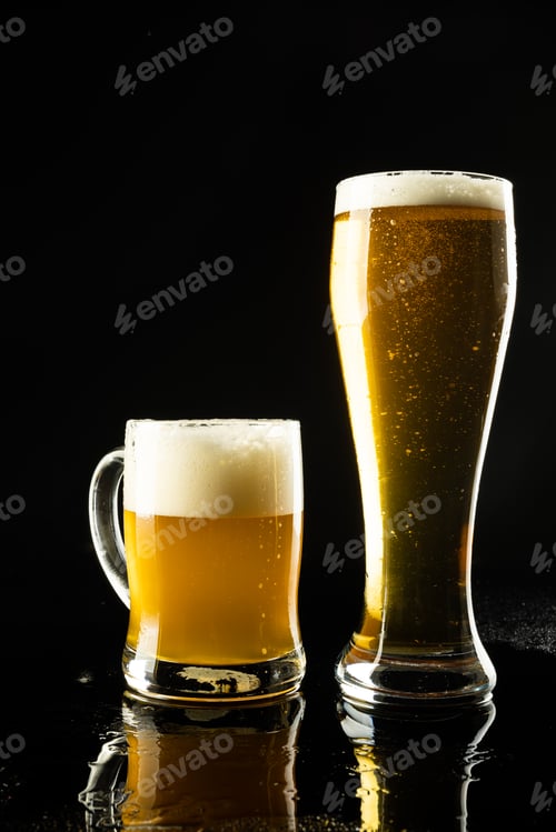 Preview: Vertical image of pint glass and glass tankard of lager beer on black background, with copy space