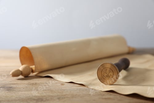 Preview: Old paper scroll and wax stamp on wooden table, closeup
