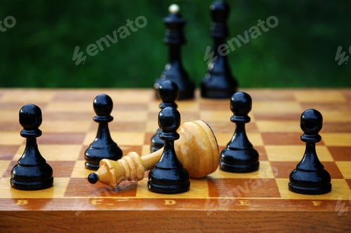 Preview: Chess end game - defeated white chess queen surrounded by black pawns
