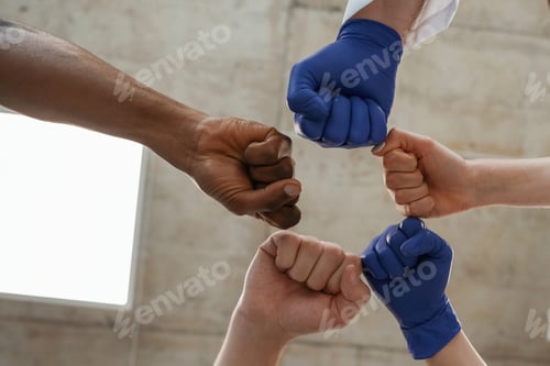 Preview: Group of doctors are holding hands in trust together