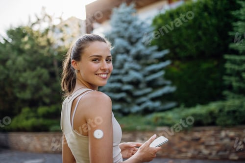 Preview: Beautiful diabetic woman preparing for outdoor workout in the city.