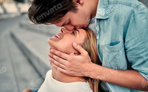 Preview: Romantic Moment: Man Kisses Woman on Forehead