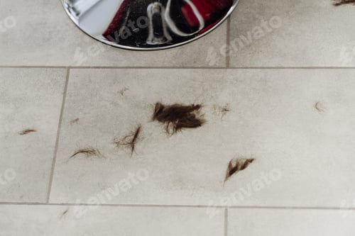 Preview: Cut hair on the floor in hairdressing salon.