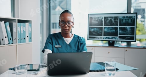 Preview: Black woman, doctor and check laptop at hospital of xray study, lab results and schedule update. Pe