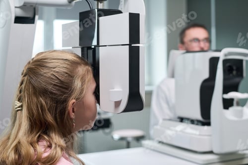 Preview: Girl Undergoing Eye Examination with Ophthalmologist in Clinic