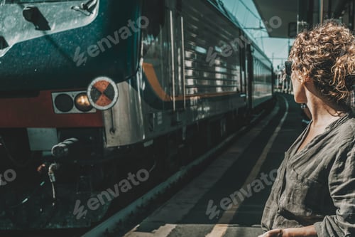 Preview: One tourist traveler woman waiting train at the station. Concept of travel for business or vacation