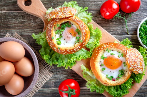 Preview: Egg baked in a soft bun with ham, fresh herbs. Delicious and quick breakfast. Top view