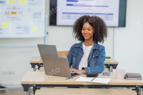 Preview: Excited happy Asian woman african american sitting on desk in workplace, doing planning analyzing