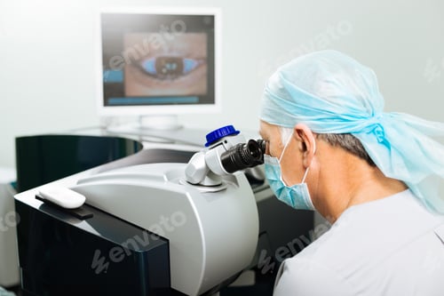 Preview: Professional mature doctor looking into the device