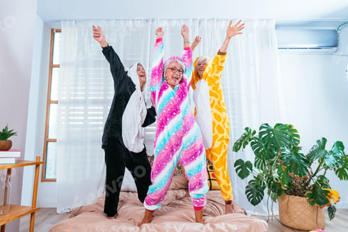Preview: Beautiful senior women having funny pajama party at home