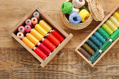 Preview: Containers with set of color sewing threads on wooden background
