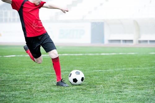 Preview: Football Player Kicking Ball