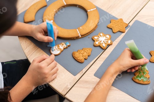 Preview: Child girl prepare ginger cookies for Christmas holiday and play with cookie cutters. Christmas time