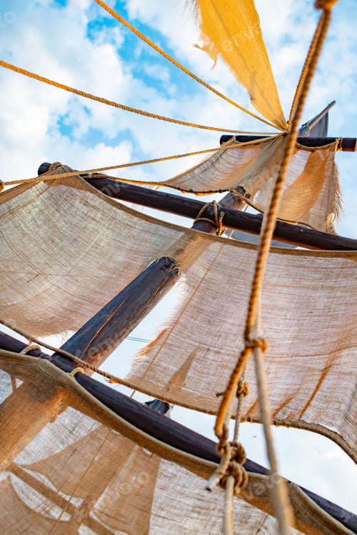 Preview: Bottom view of a ship mast with beige sails
