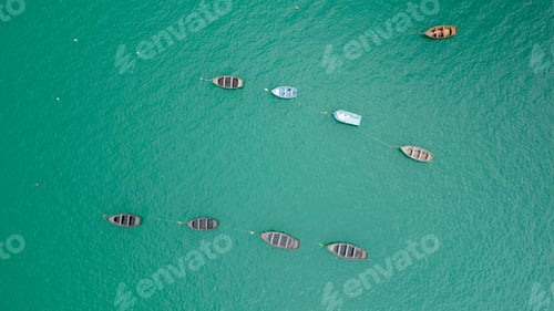 Preview: Beautiful turquoise ocean water with wooden boats on the water. Top view aerial photo.