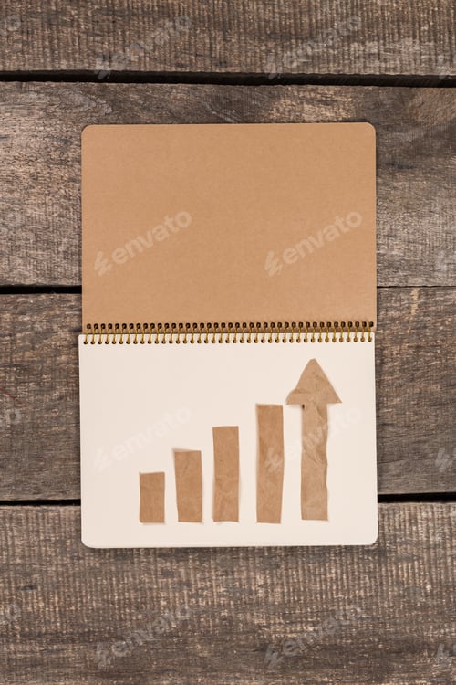 Preview: Growth chart made with tape on notepad placed on wooden surface