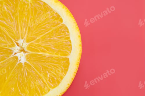 Preview: Top view of a one orange fruit slice on bright background in red color