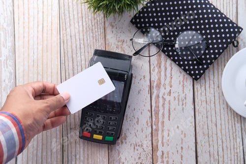 Preview: contactless payment concept with young man paying with credit card
