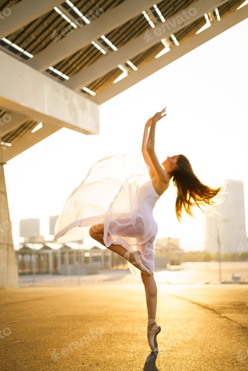Preview: Female Ballerina dancing in the street during sunset.