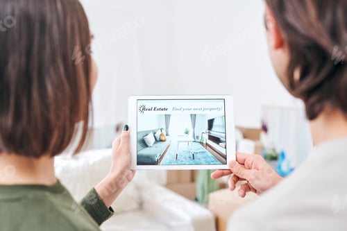 Preview: Young couple holding tablet with advertisement of real estate on sale