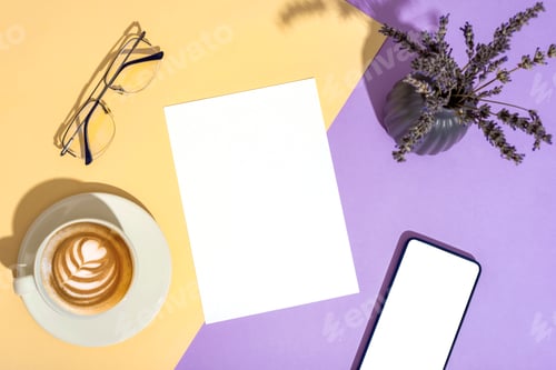 Preview: Desktop with blank paper, glasses, coffee cup, mobile phone and lavender flowers in vase