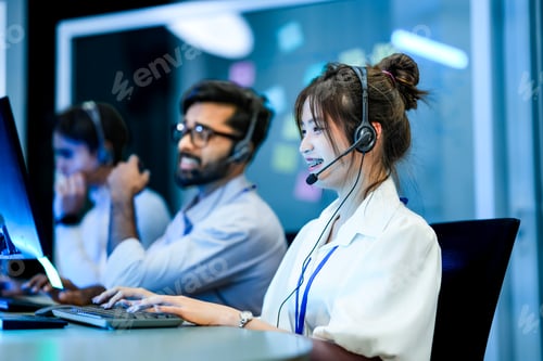Preview: diverse team of technical support specialists works a late shift in a busy call center.