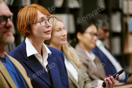 Preview: Caucasian Middle Aged Woman Attending Presentation with Diverse Audience