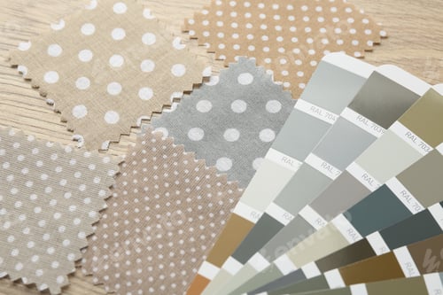 Preview: Samples of colorful fabrics and color palettes on wooden table, closeup