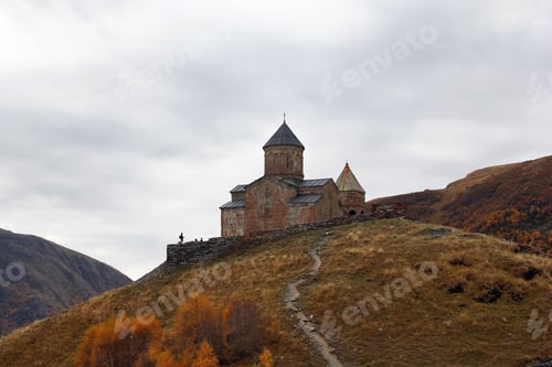 Preview: Colorful autumn landscape with Gergeti Trinity Church on in the Caucasus Mountains, Georgia.